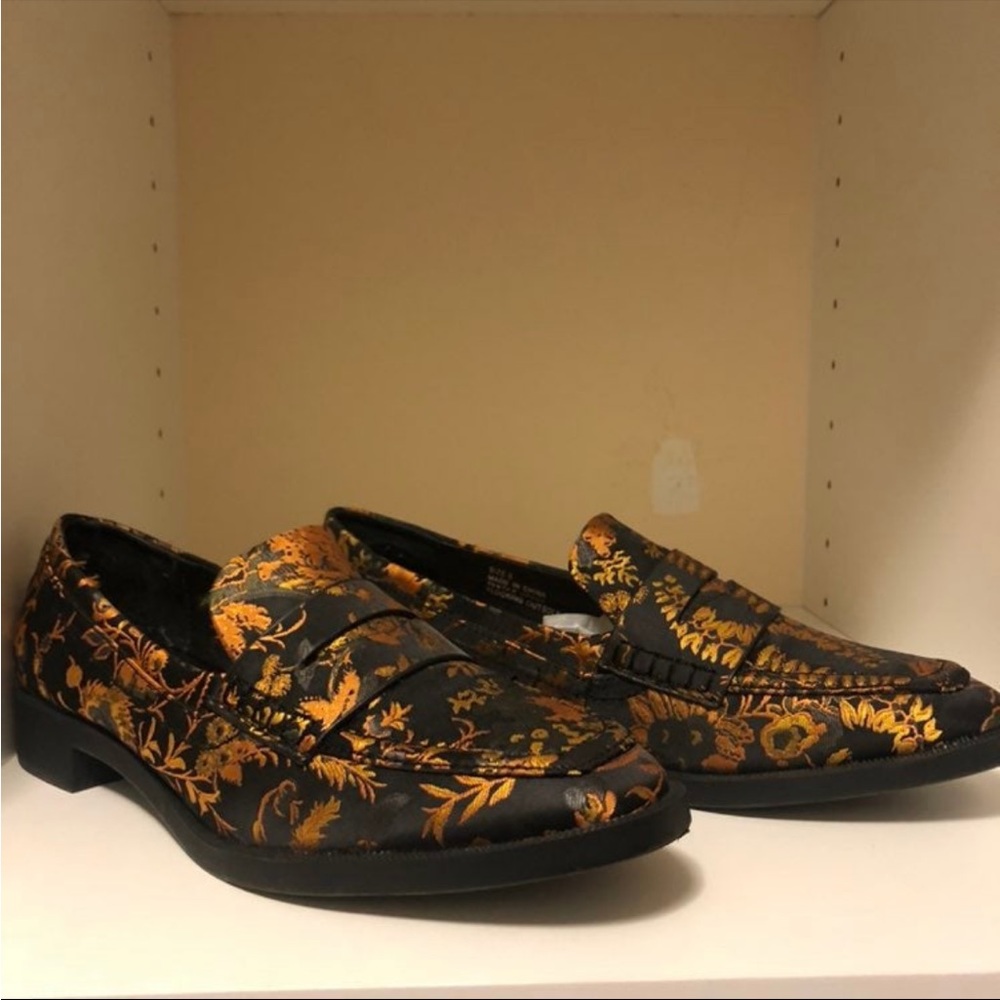 Gold and black loafers